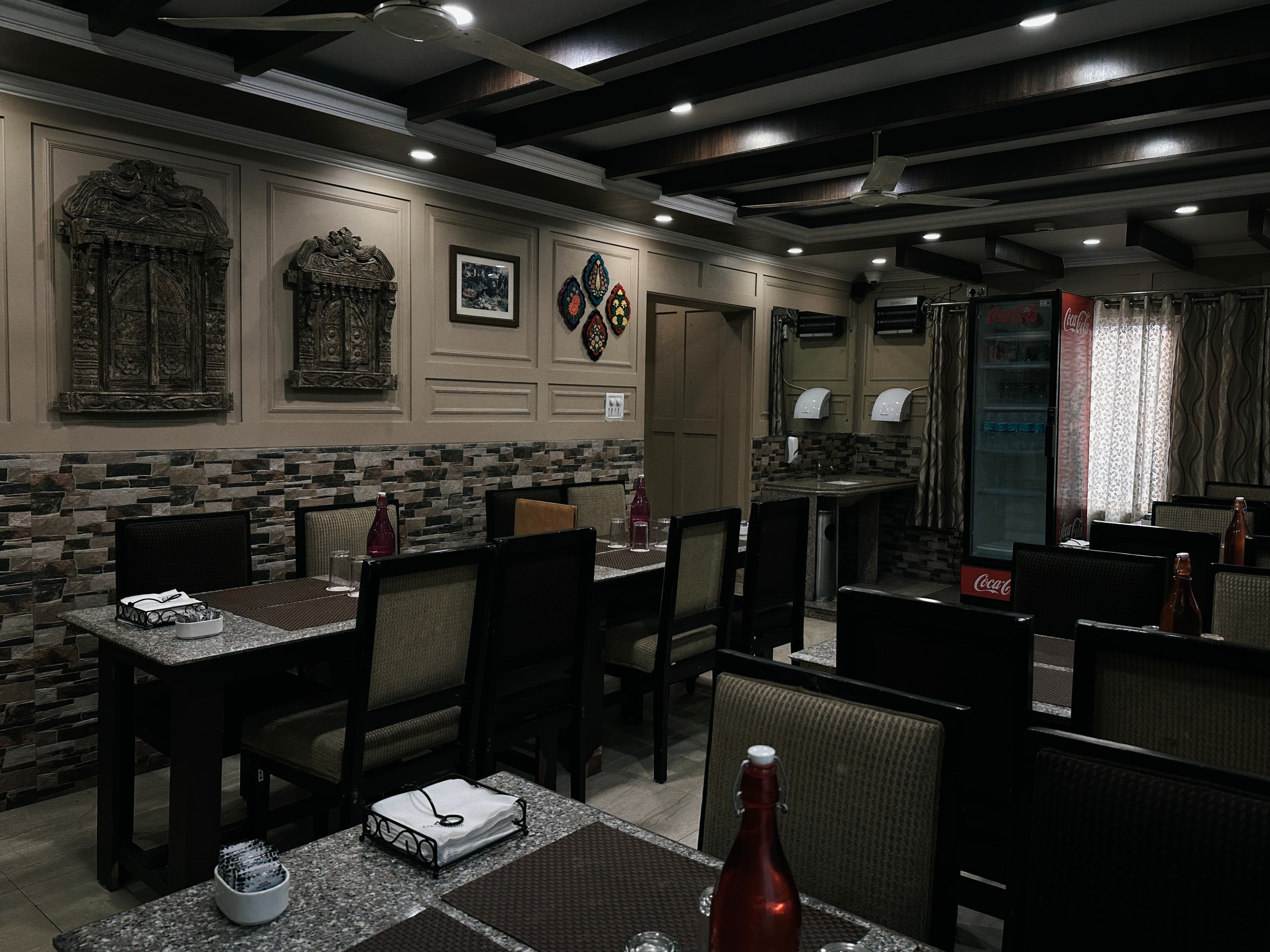 Atmospheric view of a restaurant bar with a martini glass in focus